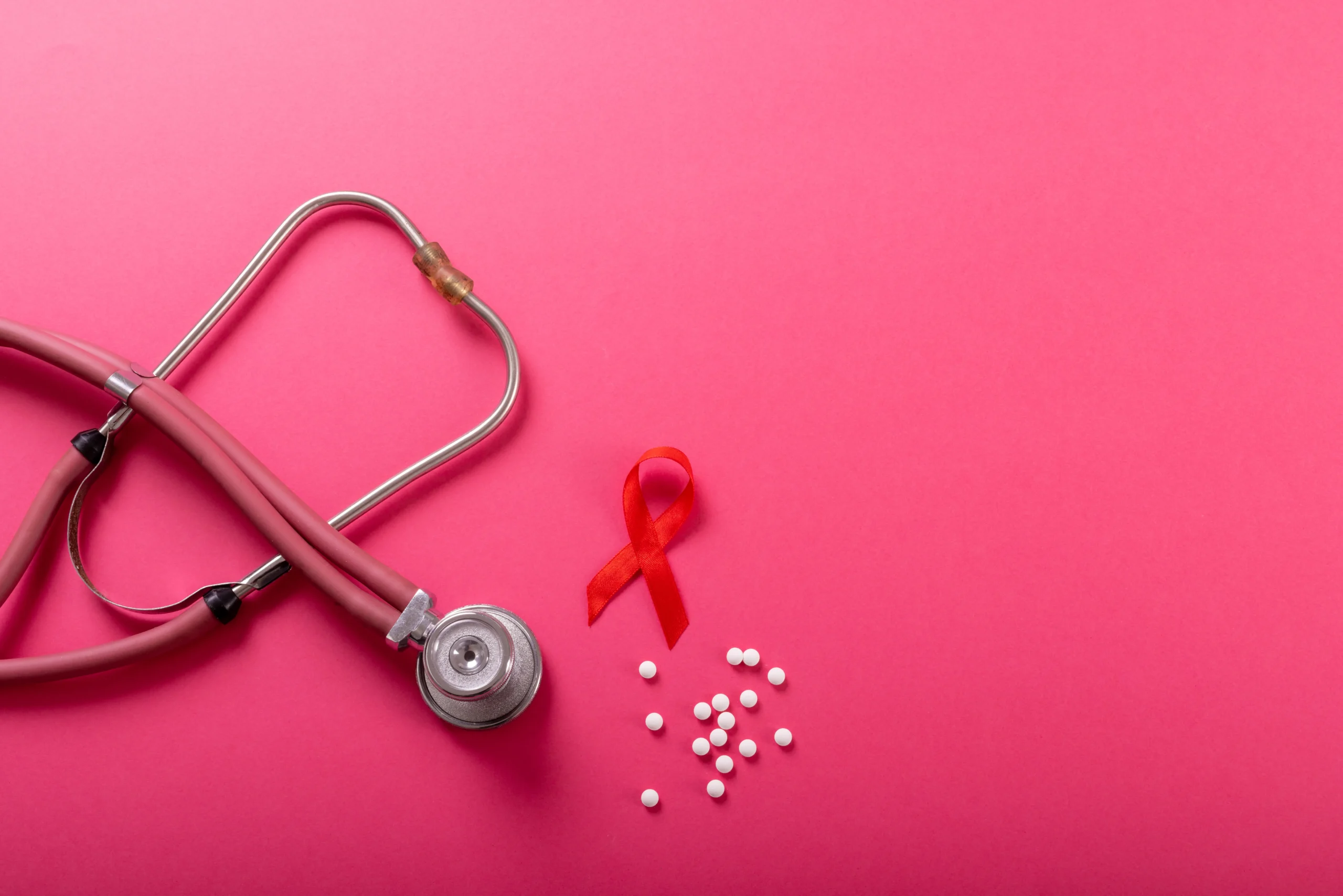 Stethoscope, ribbon, and tablets symbolizing HIV PrEP, prep how effective prevention can be, and get PrEP online services.