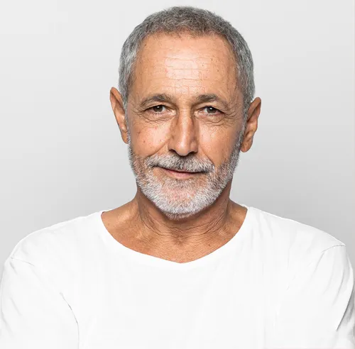 Profile photo of Oliver R. from Destin, FL a young man with short brown hair and light stubble, wearing a pale yellow t-shirt, smiling subtly against a plain light grey background.