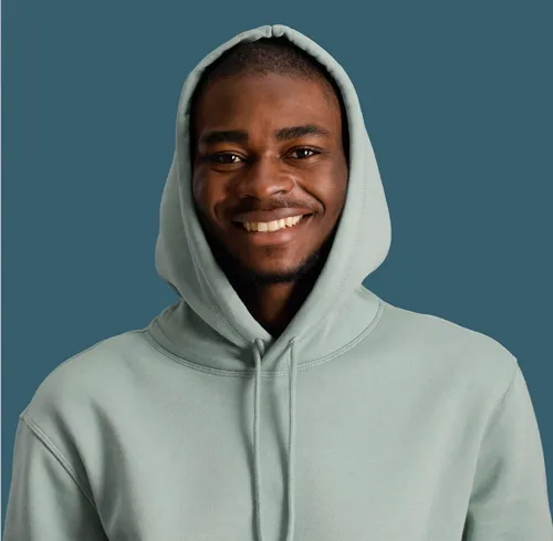 Profile photo of Noah J. from Weston, FL — a cheerful young Black man with short hair and a light beard, wearing a sage green hoodie, smiling warmly against a muted teal blue background.