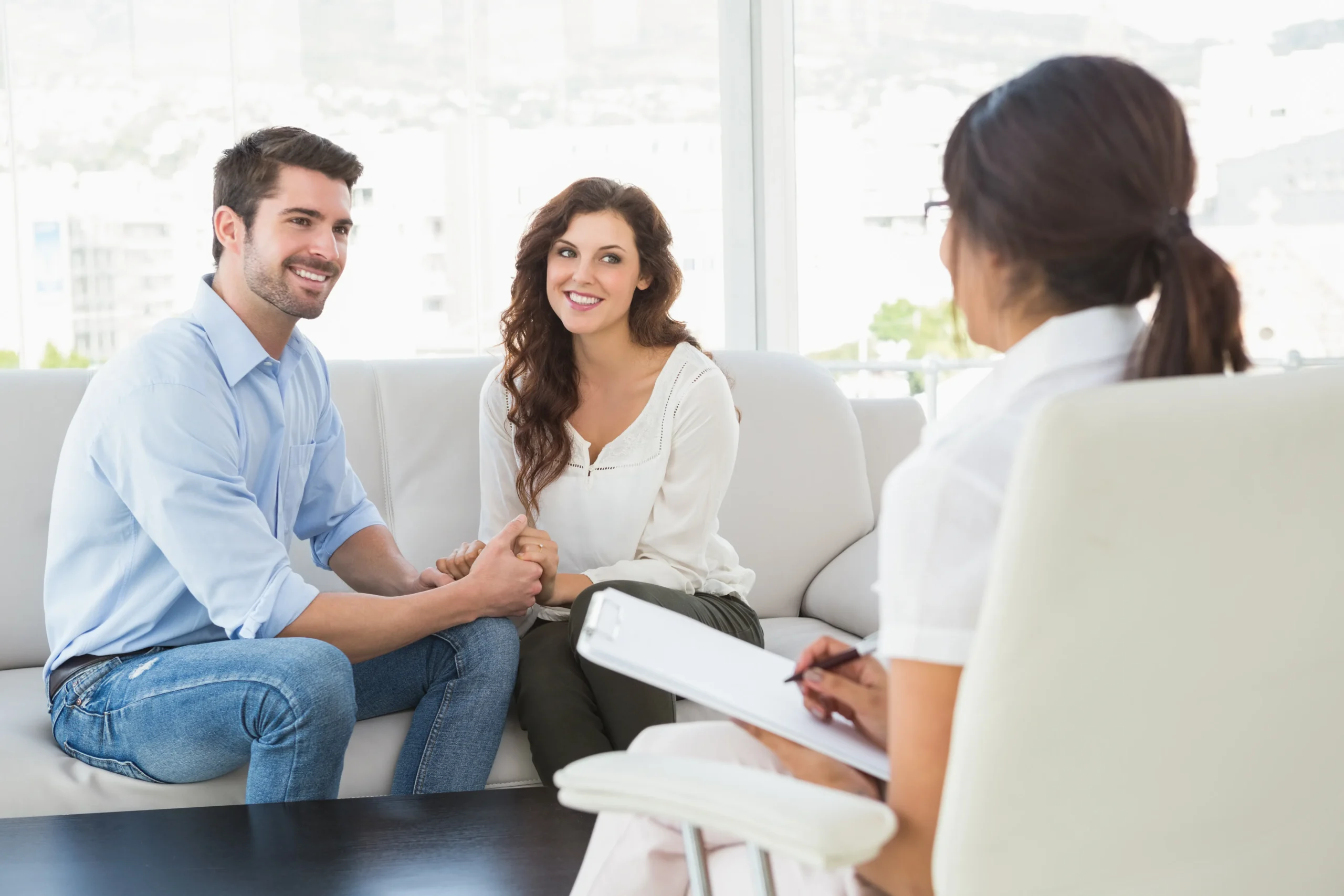 A young couple holding hands during a consultation with a healthcare provider, showing how to learn how to get PrEP online in Florida without visiting a clinic.
