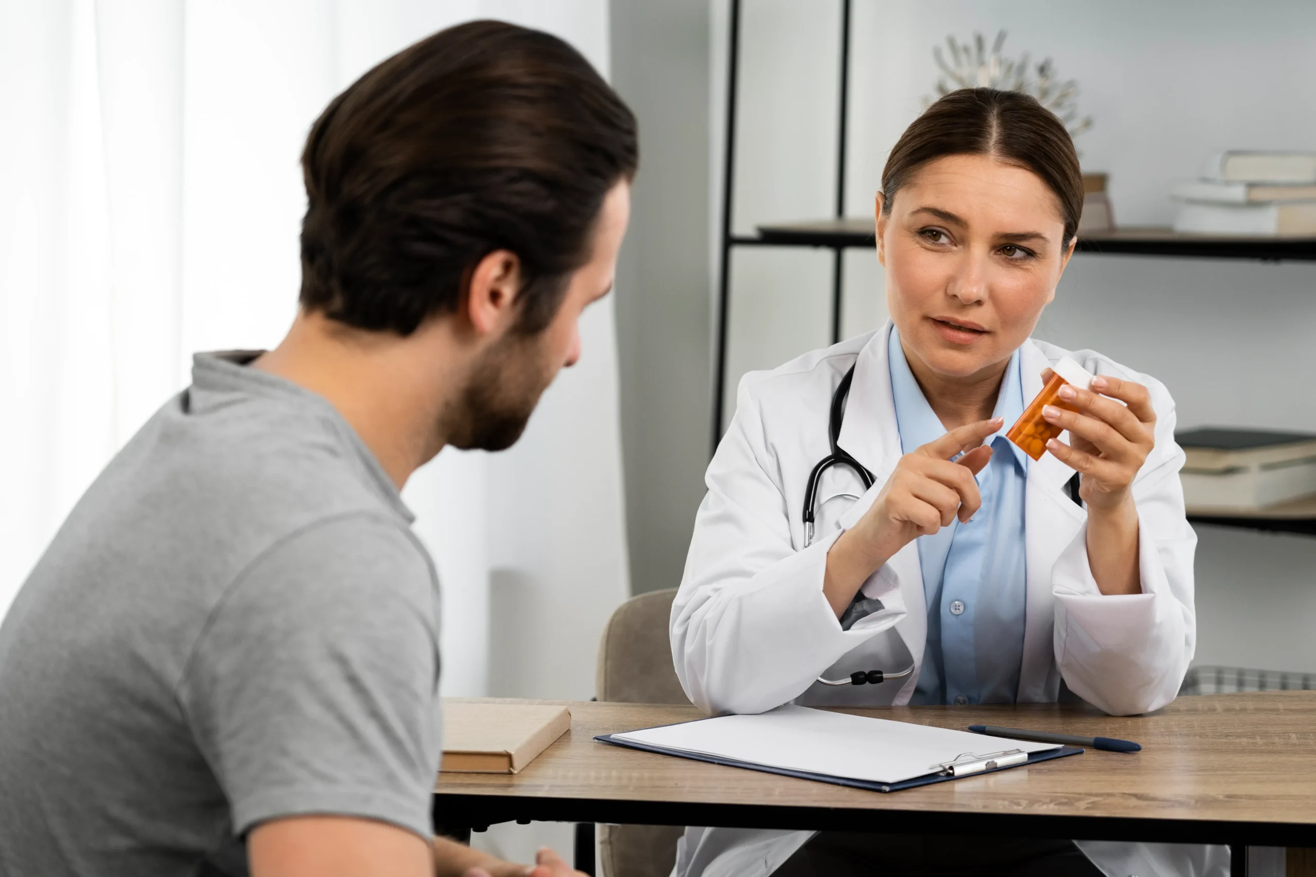 A physician consulting with a patient in her office about securing a PrEP online prescription through modern PrEP telehealth platforms.