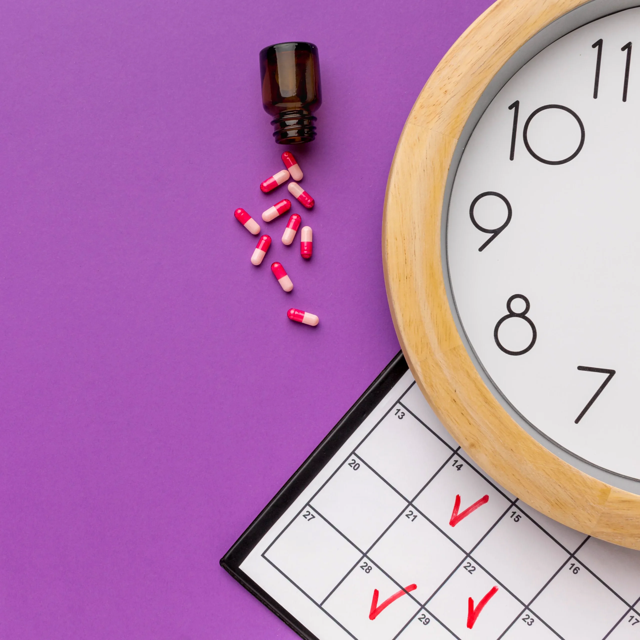 An overhead shot of medical capsules spilling near a calendar and a wall clock, illustrating timely habits on how to prevent HIV infection.
