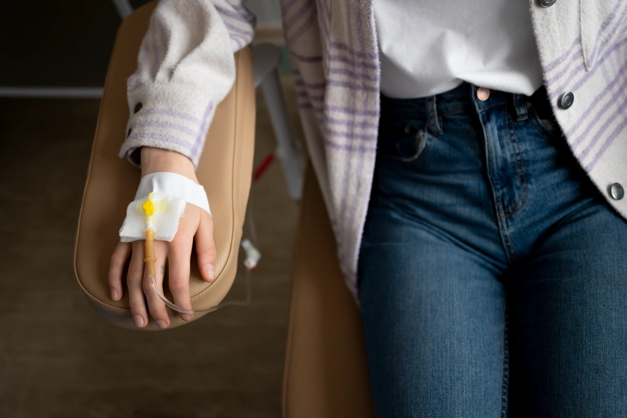 Close-up of a patient receiving IV fluids prior to setting up a PrEP consultation online.
