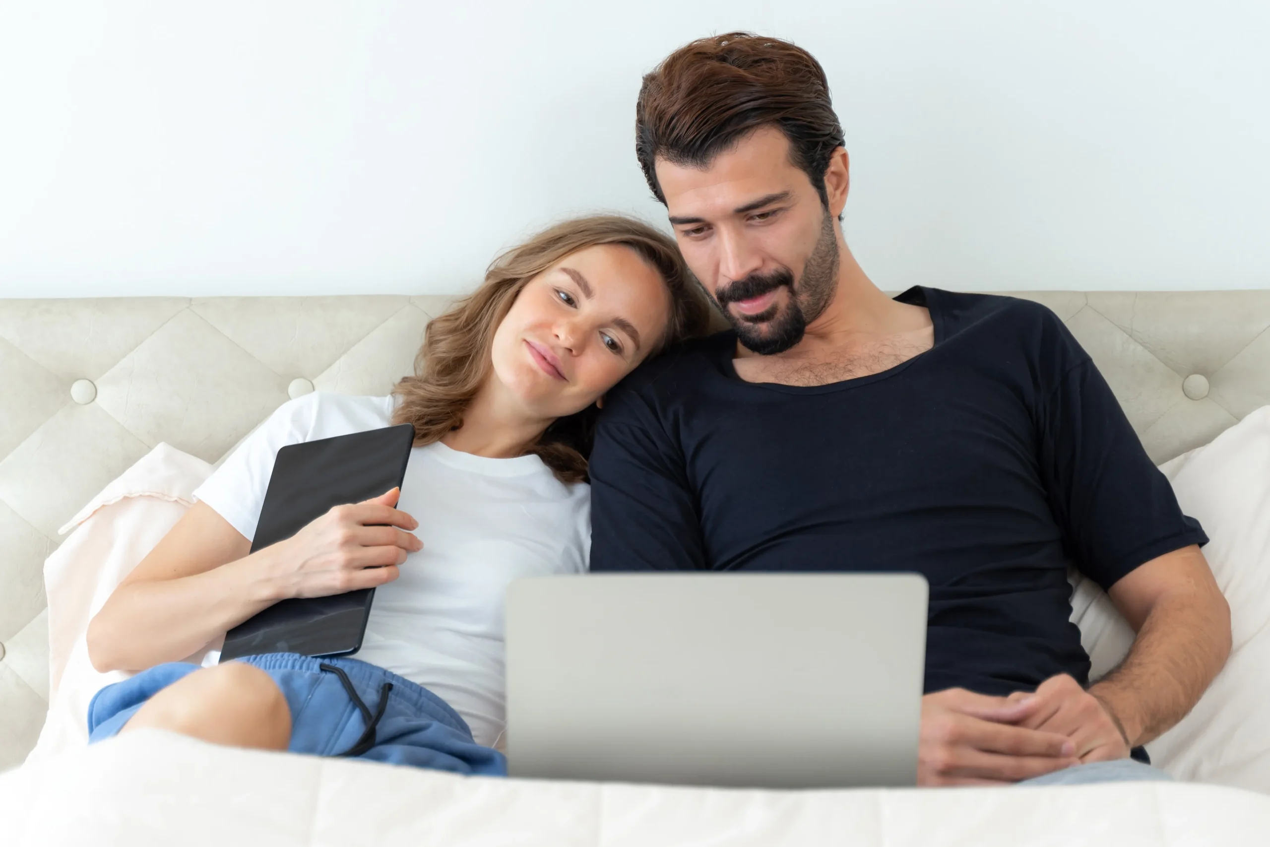 Man and woman looking at a laptop computer to research online HIV prevention services.