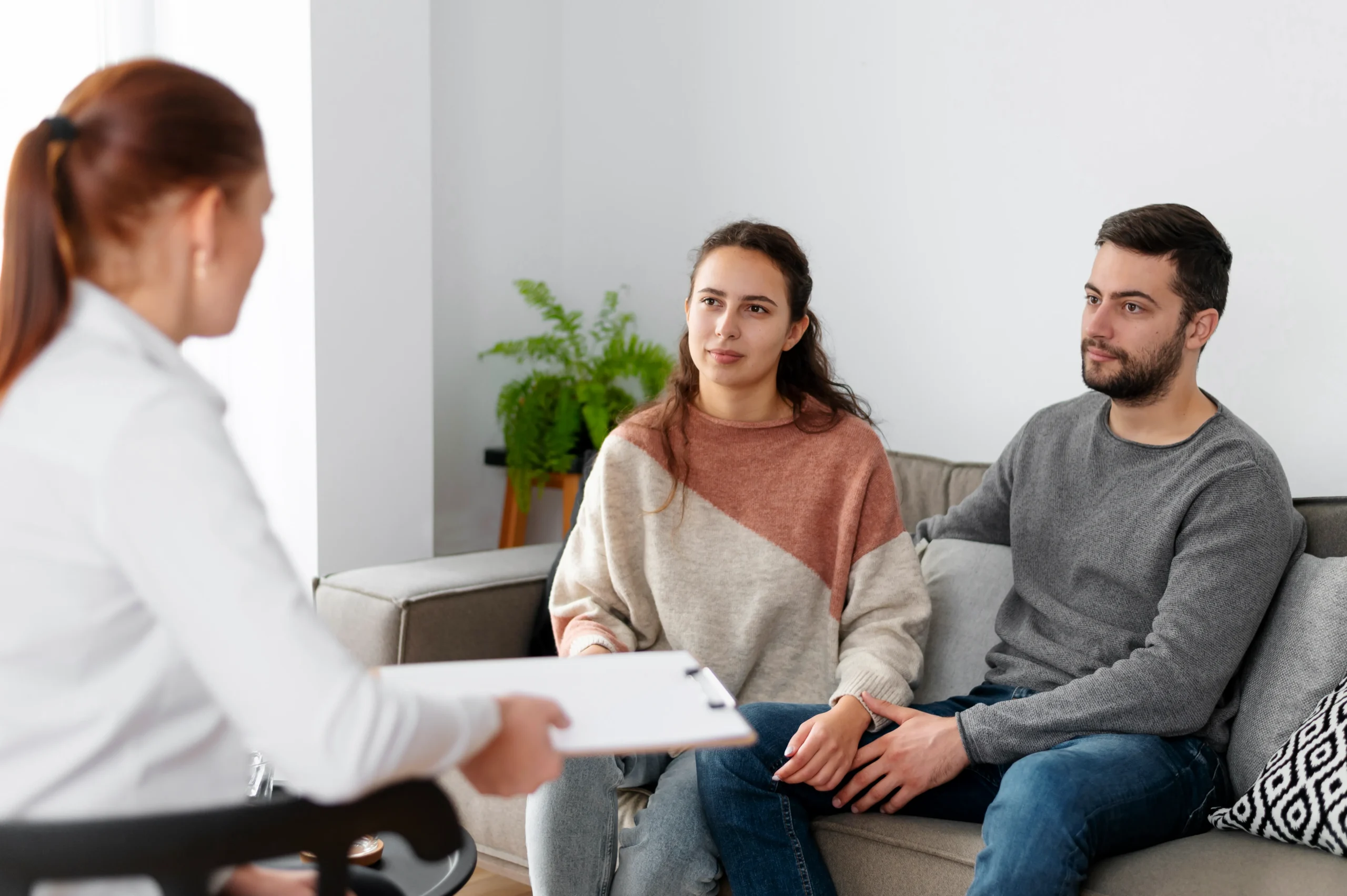 Medical professional offering consultation forms to a couple exploring HIV prevention methods.