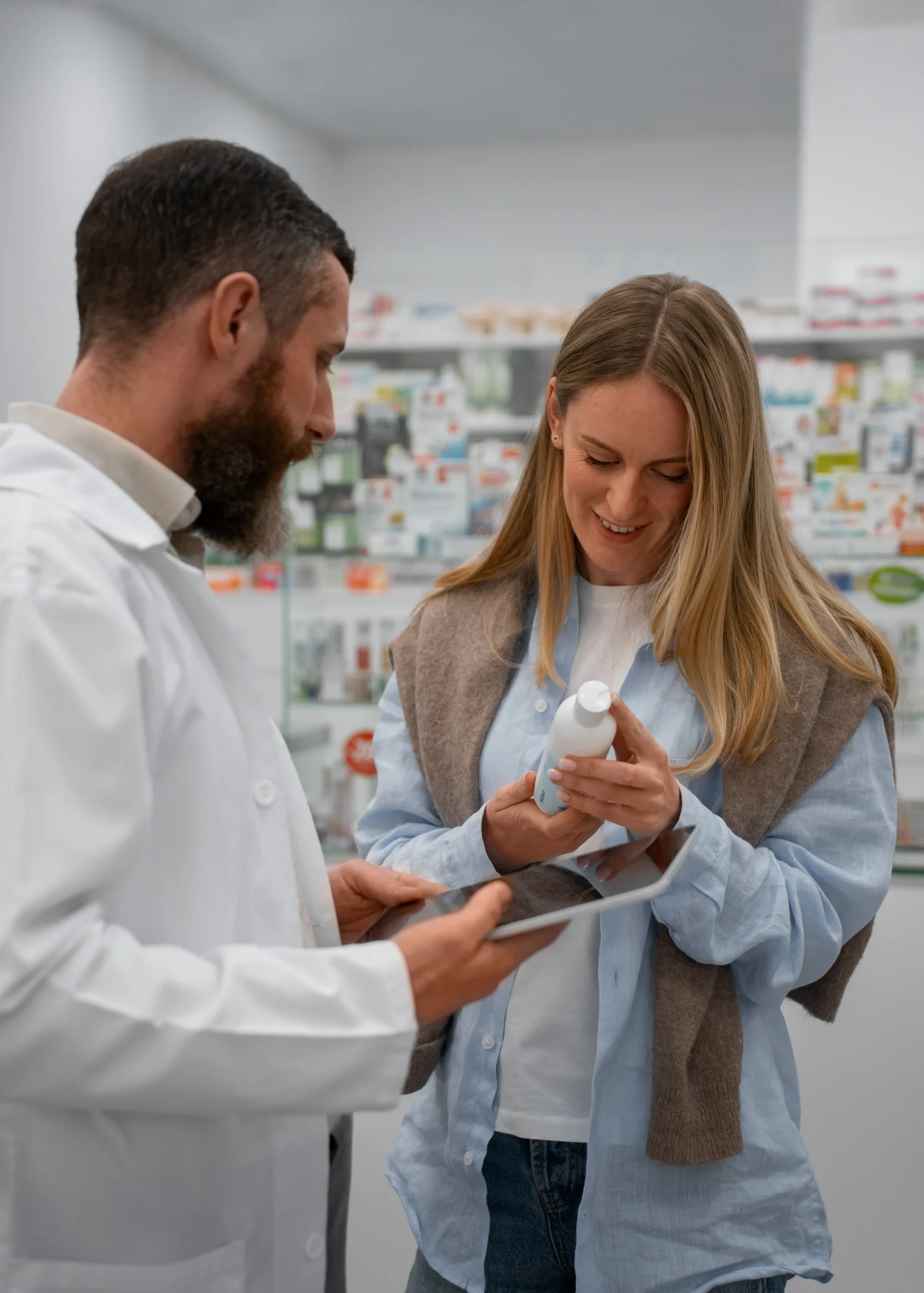 Pharmacist discussing prescription options on a tablet with a patient receiving an Online STD treatment.
