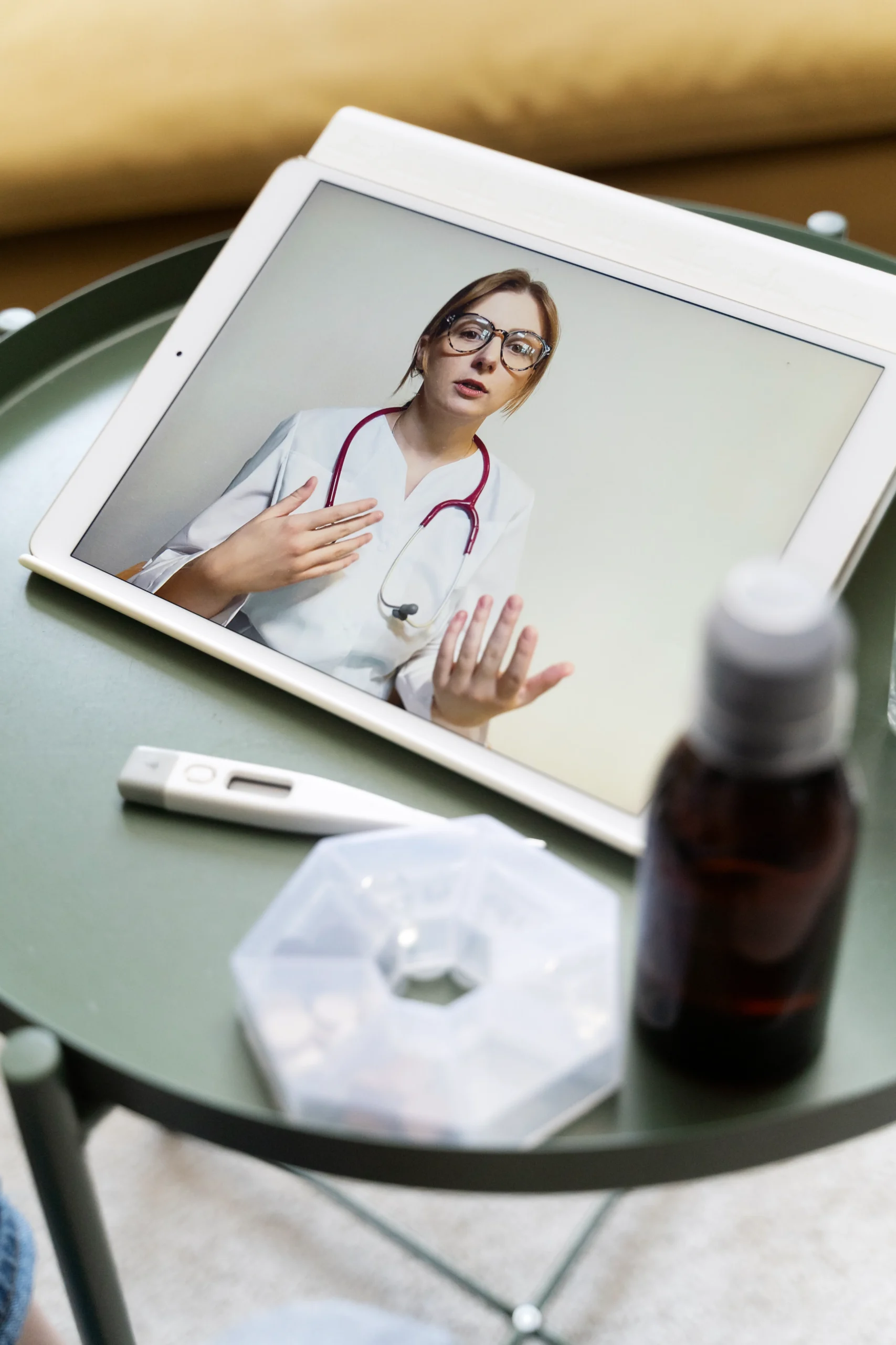 Tablet showing a telehealth doctor explaining confidential STI treatment online.
