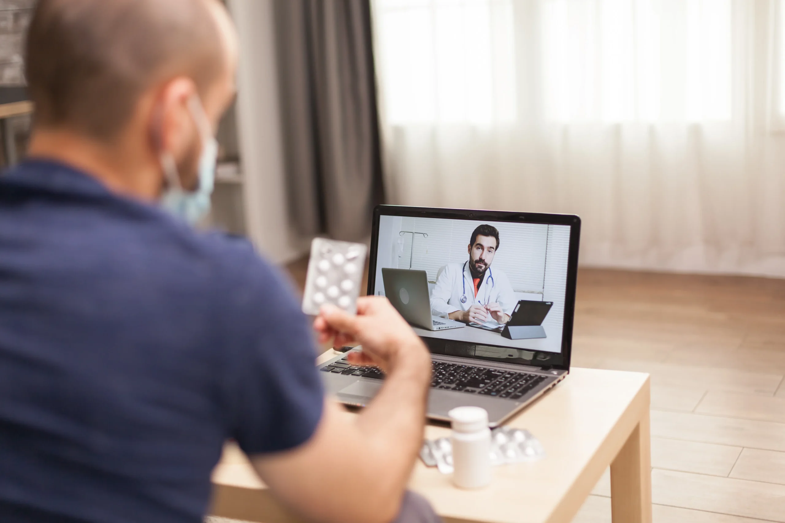 Patient consulting with a virtual doctor during a PrEP telehealth appointment on a laptop.