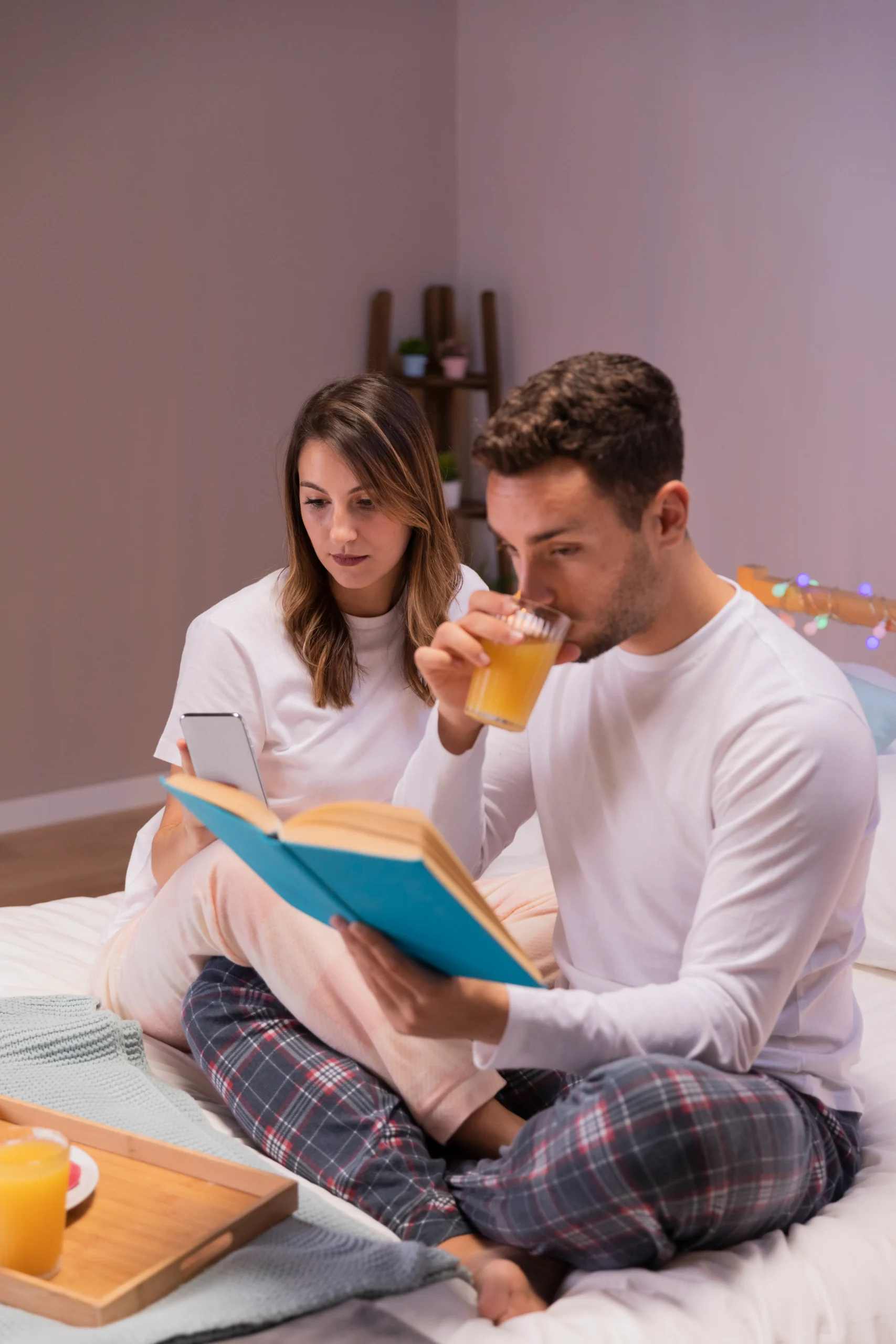 Woman using her smartphone in bed to consult healthcare services and order PrEP online.